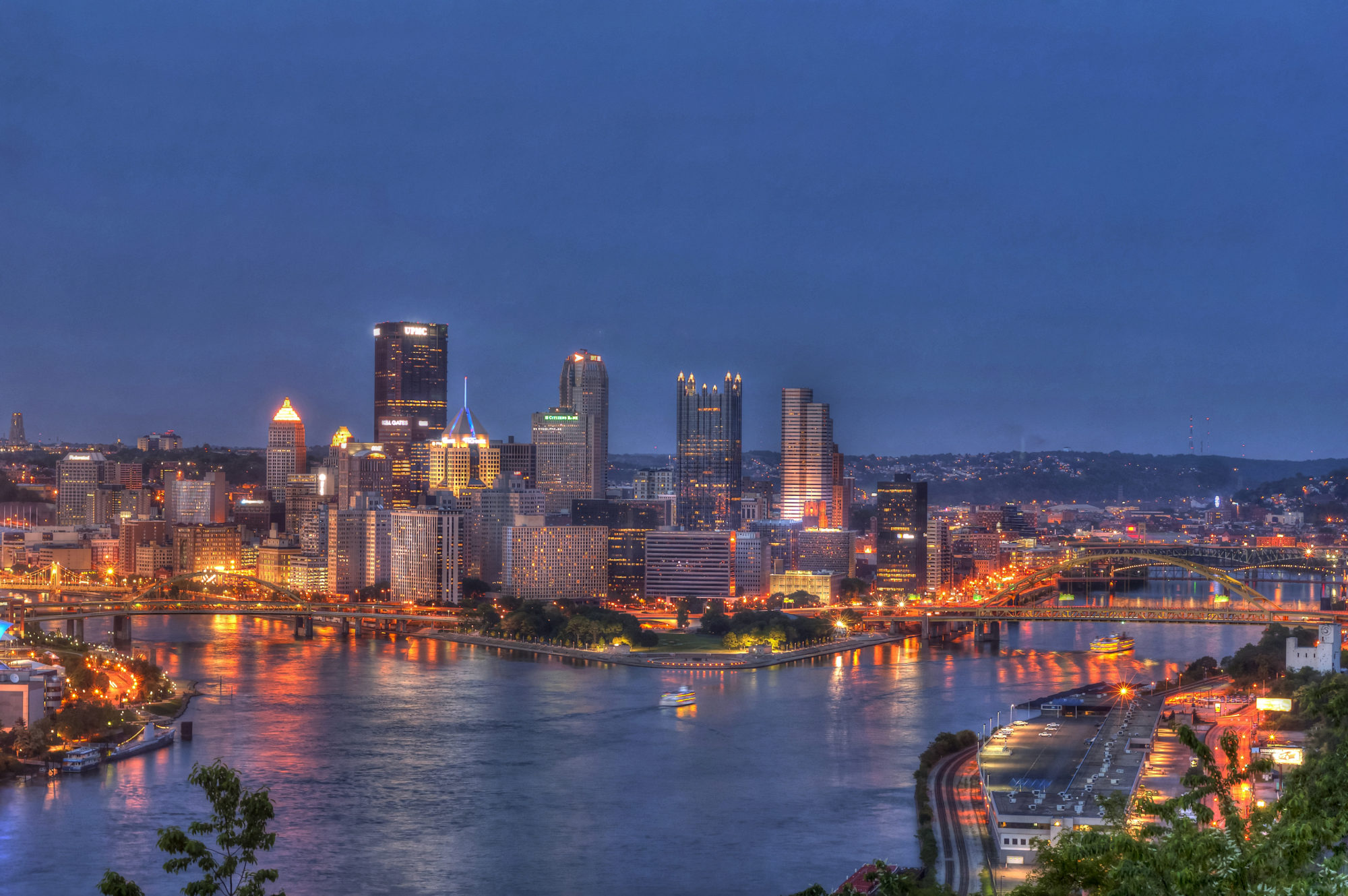 Nighttime photo of Pittsburgh with the Point in the foreground