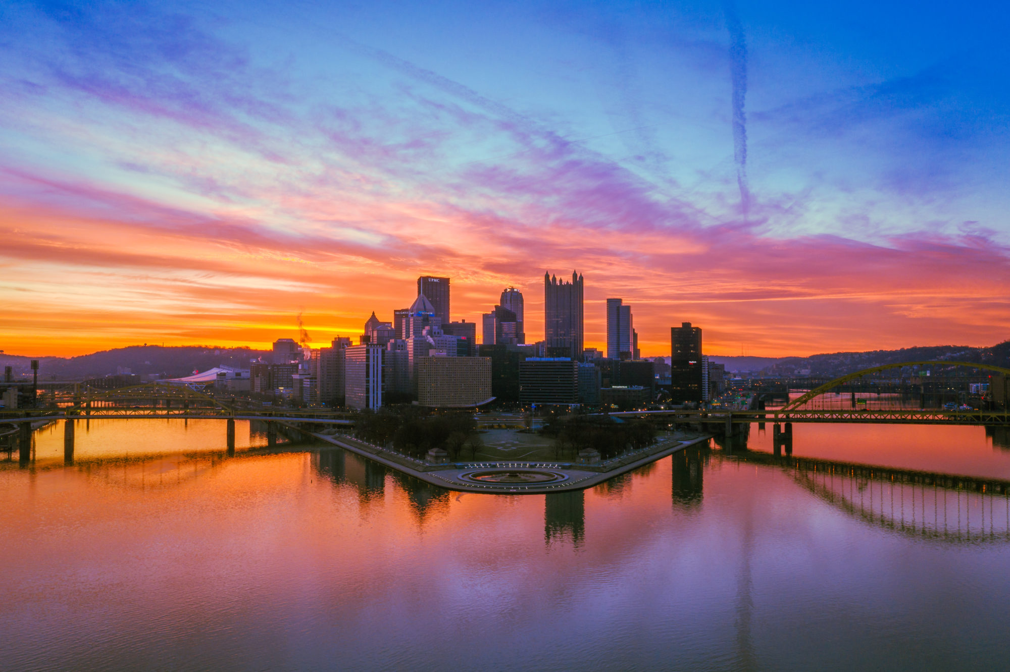 Scenic sunset shot of downtown Pittsburgh with The Point in the foreground