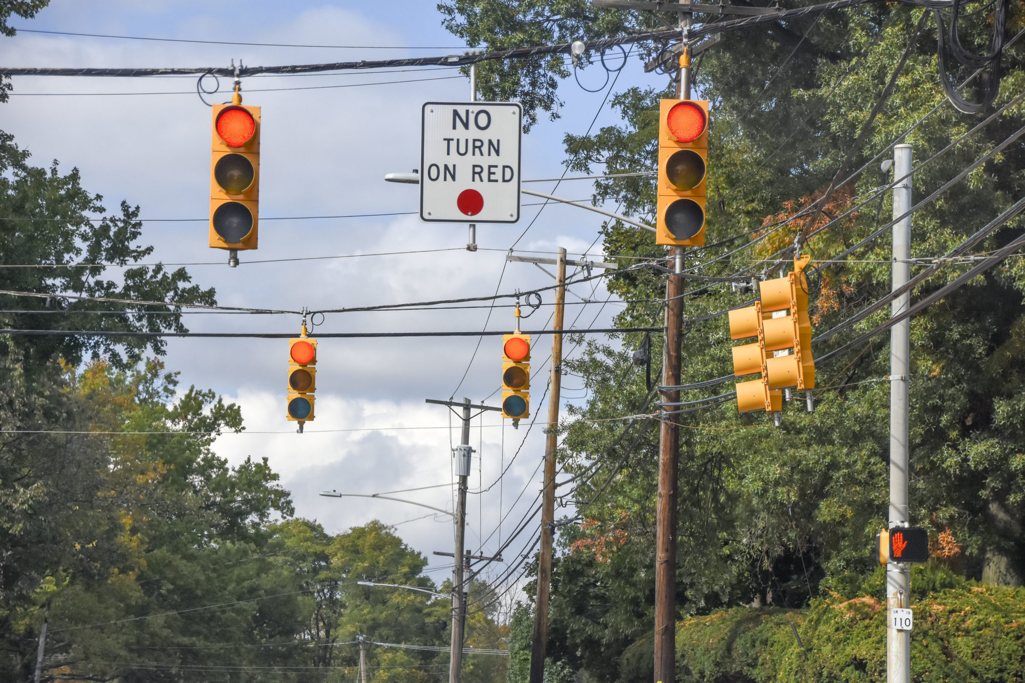 Close up of Red Traffic Lights. A "No Turn On Red" Sign is present.